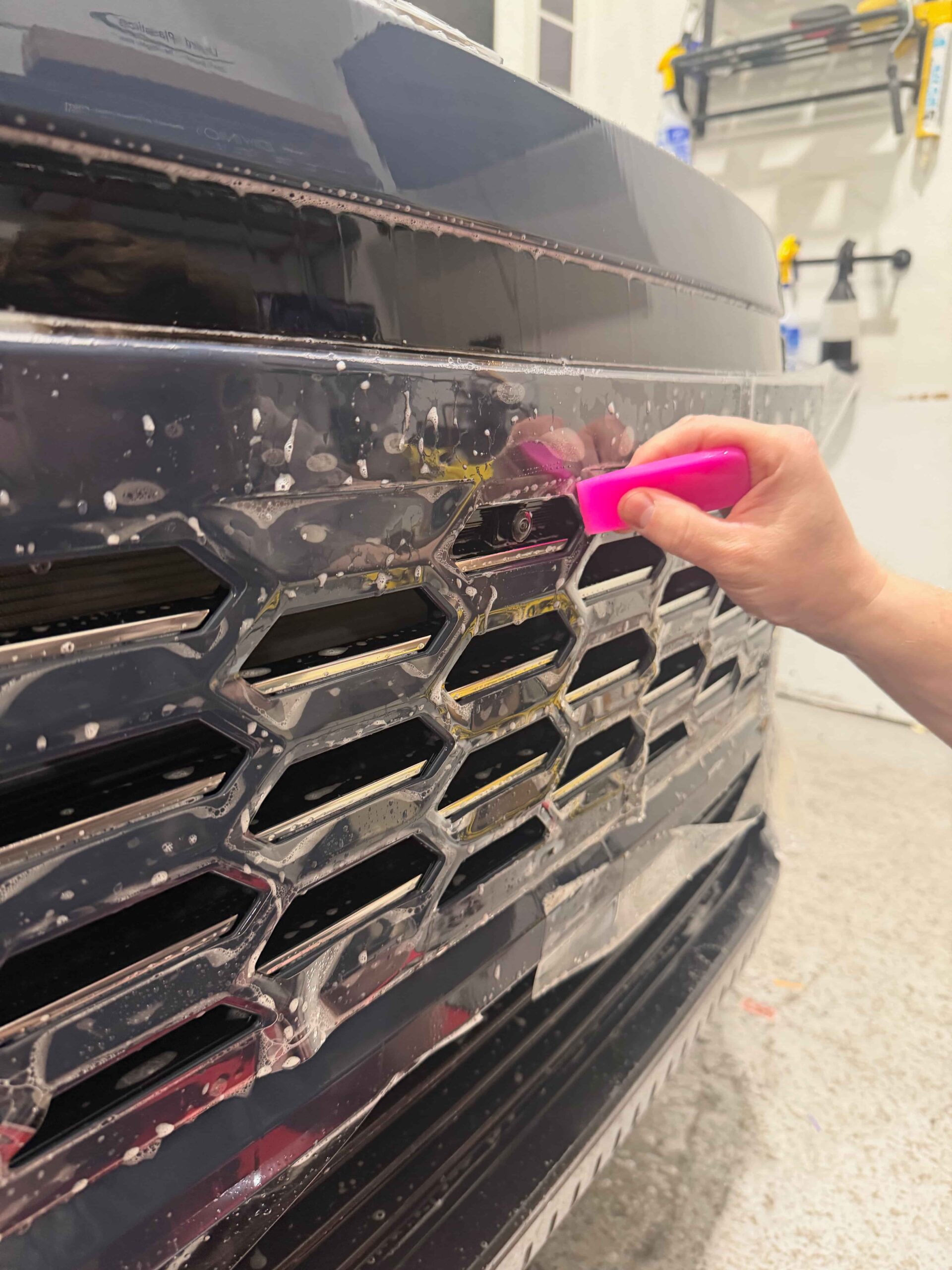 The Wrap Factory applying clear wrap to SUV front grille and camera